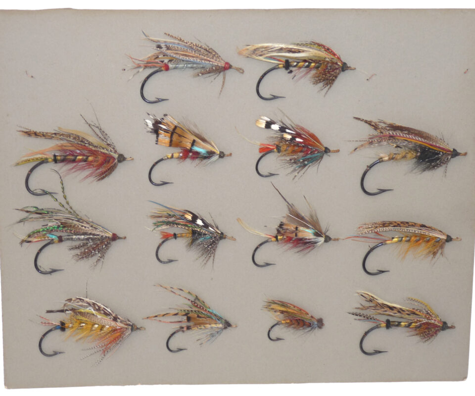 14 antique large gut eyed salmon flies stitched onto grey card, hook sizes 1/0 to 7/0