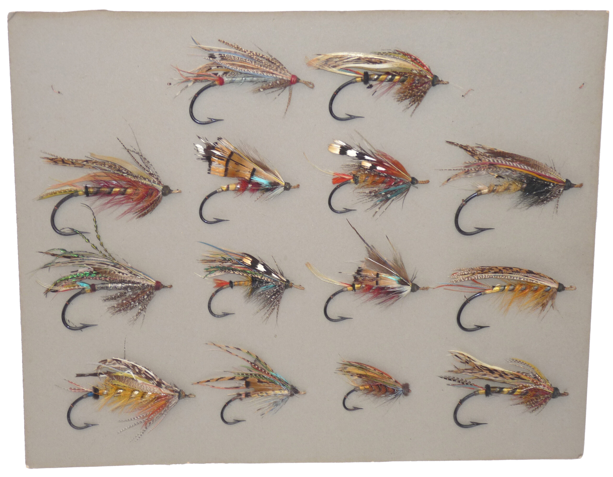 14 antique large gut eyed salmon flies stitched onto grey card, hook sizes 1/0 to 7/0
