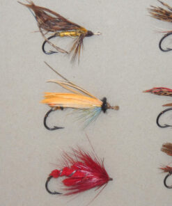 Alternative view of 27 antique gut eyed salmon flies on grey card, hook sizes 1-3