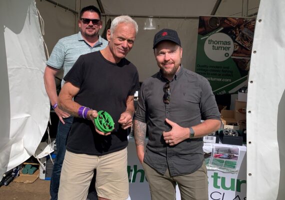 Stuart Ward owner of Kingpin, presenting Jeremy Wade with a reel
